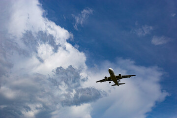 Modern passenger airplane on a blue sky