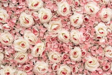 a wall of pink artificial roses