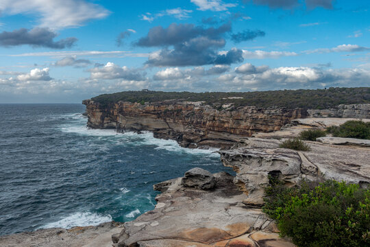 Landscape view of the coastal cliffs and sea between Maroubra Beach and Malabar Beach, Randwick, Sydney, Australia. Dramatic cloud formations on the blue sky.