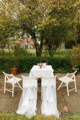 Chairs outside in the woods. Decoration for free weddings outside in the garden. Wedding in nature in spring