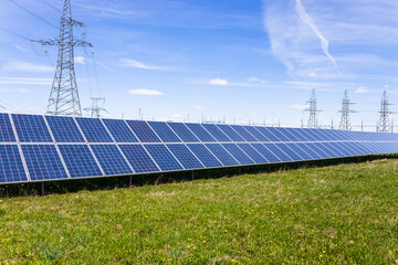 Solar panels, high voltage electricity towers, and transmission power lines