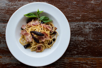 Delicious Spaghetti Bolognese or Bolognese and Tomato Sauce Garnished with parmesan cheese and basil, top view.