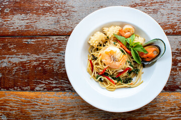 Delicious Spaghetti Bolognese or Bolognese and Tomato Sauce Garnished with parmesan cheese and basil, top view.