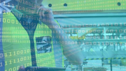 Binary coding data processing against caucasian male engineer using digital tablet at a factory - Powered by Adobe