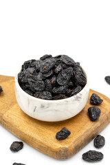 Black dried raisins on a white background. healthy and fresh.nuts. Close-up.