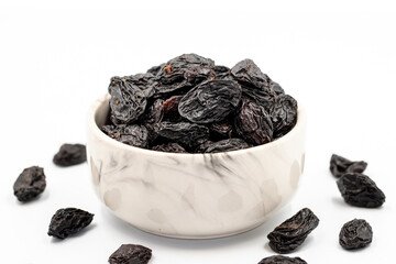 Black dried raisins on a white background. healthy and fresh.nuts. Close-up.