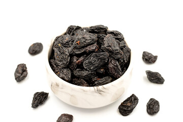 Black dried raisins on a white background. healthy and fresh.nuts. Close-up.