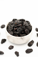 Black dried raisins on a white background. healthy and fresh.nuts. Close-up.