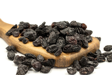 Black dried raisins on a white background. healthy and fresh.nuts. Close-up.