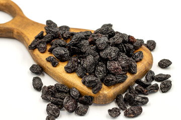 Black dried raisins on a white background. healthy and fresh.nuts. Close-up.