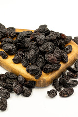 Black dried raisins on a white background. healthy and fresh.nuts. Close-up.