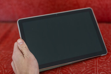 digital tablet on an old couch