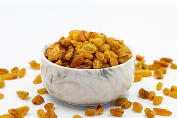 Dried raisins on a white background. Healthy and fresh.nuts. Close-up. - obrazy, fototapety, plakaty