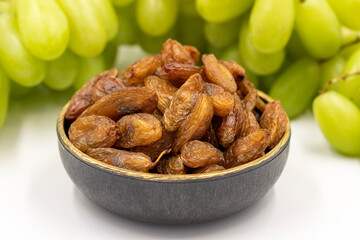 Dried raisins on a white background. Raw grapes and raisins. Healthy and fresh nuts. close-up. Local name besni uzum