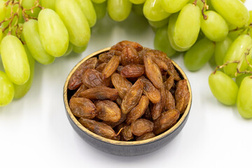 Dried raisins on a white background. Raw grapes and raisins. Healthy and fresh nuts. close-up....