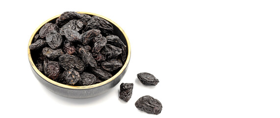 Black dried raisins on a white background. healthy and fresh.nuts. Close-up. Copy space. Space for text