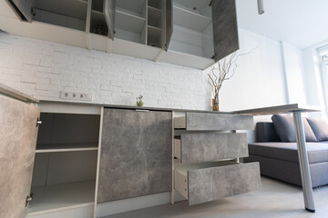 Fototapeta na wymiar Modern minimalistic dark gray loft style studio apartment interior design. kitchen, sitting area.