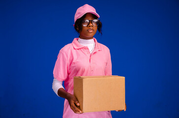 beautiful african female courier worker holding a box