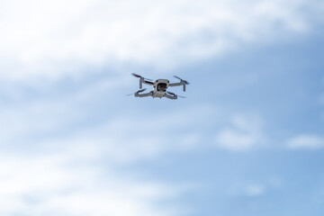 Fototapeta na wymiar Drone. The quadcopter flies in the sky. Minidrone in flight. Photo