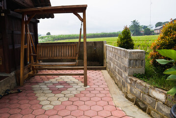 the swing chair next to the wooden house