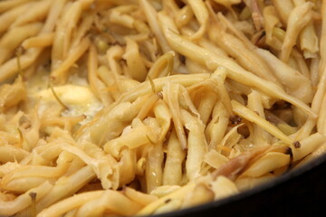 Fresh butter beans are baked in a metal pan. Close up of yellow string beans in a pan, Fried butter beans