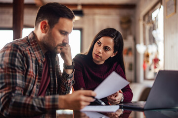Male boss working with his client, looking serious.