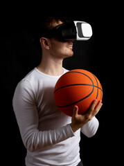 Modern young man experiencing virtual reality glasses in studio