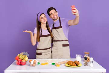 Portrait of two positive people make selfie recording video arm hold copyspace isolated on purple color background