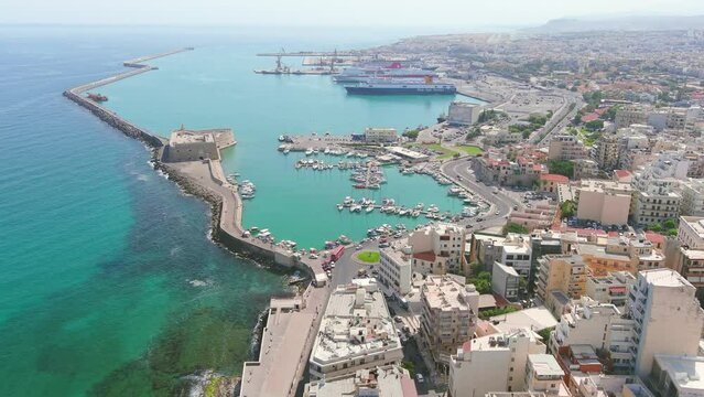 Heraklion, Greece: Aerial view of capital city of Greek island of Crete, Rocca a Mare Fortress, clear waters of Mediterranean Sea, yachts and ships in city marina - landscape panorama of Europe from a