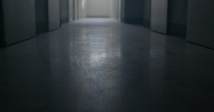 The movement of the floor in the dark corridor of the prison. A glare of light in the menacing floor, the surface. There is light at the end of the corridor. Low mental state.