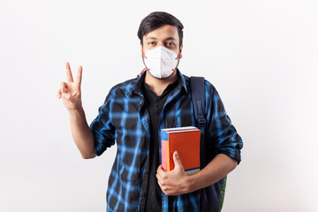 adult student wearing mask showing two finger peace sign gesture for success