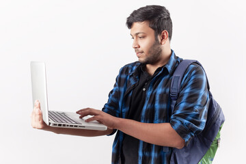 adult indian student using laptop technology in white background