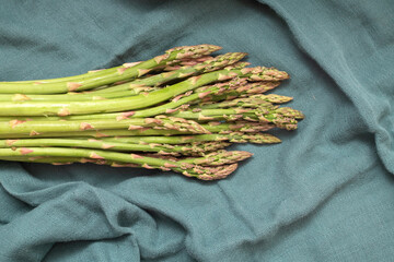 Green asparagus on green cloth