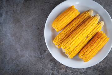 Boiled corn on a white plate.