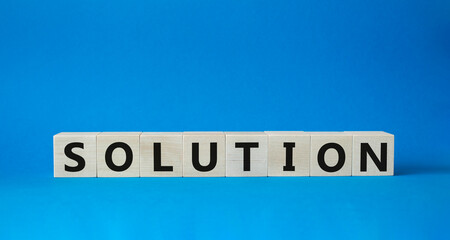Solution symbol. Wooden blocks with word Solution. Beautiful blue background. Business and Solution concept. Copy space.
