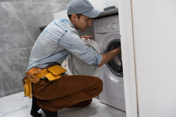 Plumber repairman repairing washing machine