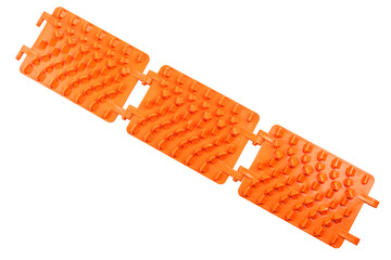 orange plastic foldable emergency traction pads isolated on white background, useful for off-road...