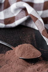 chocolate cocoa milk powder on a black stone background