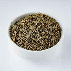 fragrant dried thyme on a white acrylic background