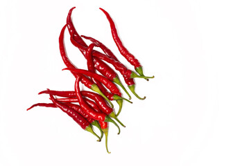 a lot of hot red peppers are lying in a pile on a white background