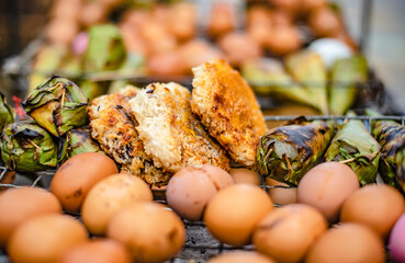 Toasted sticky rice and toasted eggs for sale on roadside carts in Bangkok, Thailand.