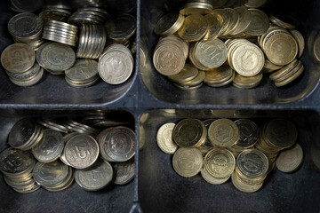 Different Turkish changes on black cash register, dusty coins, close-up, top view