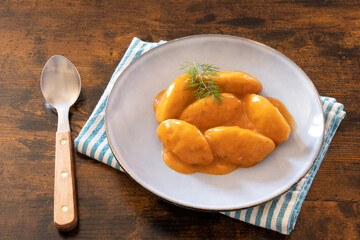 top view dumpling with tomato sauce in white plate on table