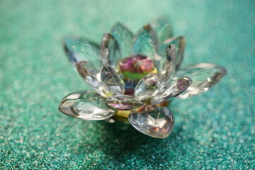 Crystal lotus on shiny green surface. Paradise bud symbol