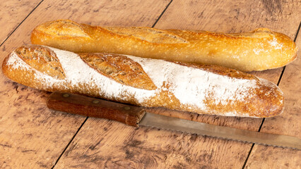 freshly baked baguettes on wooden background