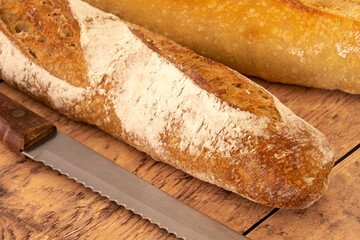 freshly baked baguettes on wooden background