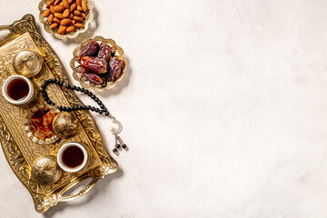 Islamic rosary with dates fruits and tea. Ramadan Kareem concept