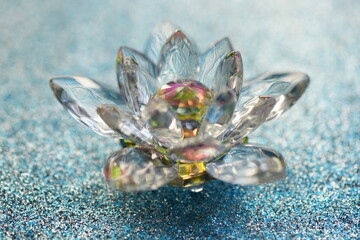 Crystal lotus on shiny blue surface. Paradise bud symbol.