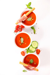 Fototapeta premium cold gazpacho with tomato, cucumber, bell pepper and basil on white background
