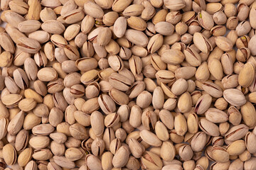 background of unpeeled almond nuts, close up